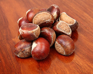 Image showing chestnuts on wooden background