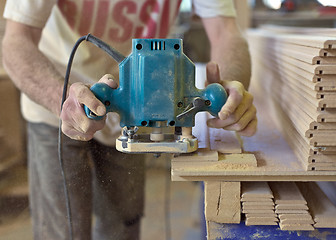 Image showing Carpentry. Carpenter working in his workshop