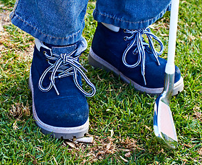 Image showing boy shoes and golf club on grass