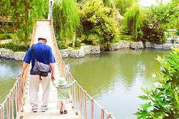 Image showing father and son on bridge