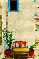 Image showing Antique bench against a wall.