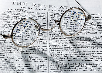 Image showing Antique reading glasses on page of bible