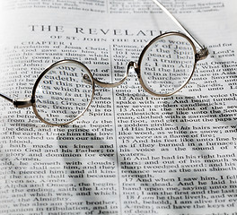 Image showing Antique reading glasses on page of bible