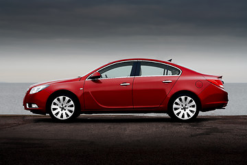 Image showing Side view of cherry red car