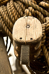 Image showing Old rope and wooden block pulleys