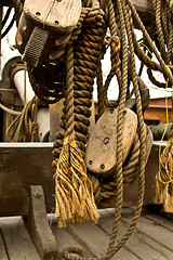 Image showing Old rope and wooden block pulleys