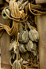 Image showing Old rope and wooden block pulleys