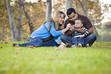 Image showing Happy Mixed Race Ethnic Family Playing with Bubbles In The Park