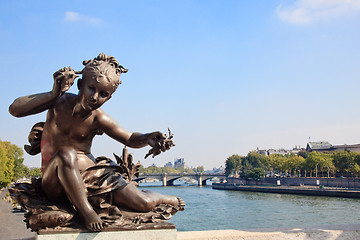 Image showing Small child statue frames view of Seine and Paris