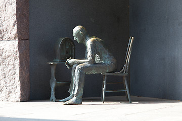 Image showing Statue of poor man listening to radio