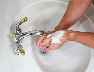 Image showing Senior male wash hands with soap