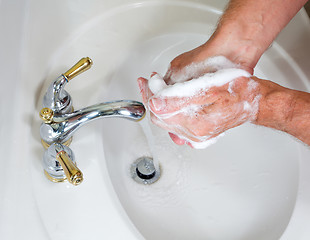 Image showing Senior male wash hands with soap