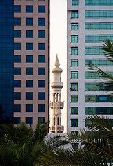 Image showing Minaret peeping between office buildings