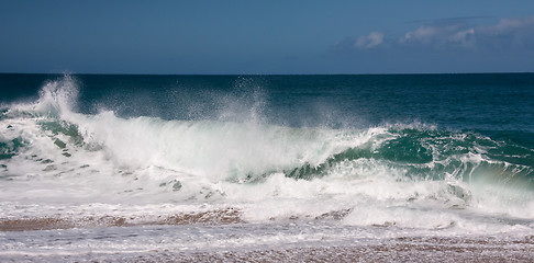 Image showing Waves breaking on sandy beach