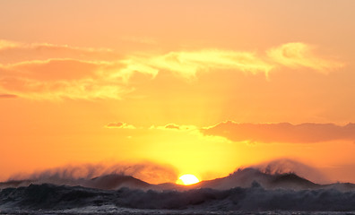 Image showing Sun setting over stormy sea