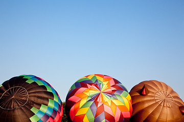 Image showing Three Hot air balloons being inflated