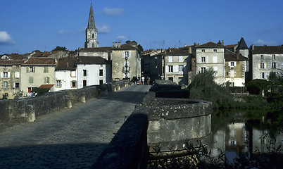 Image showing Old stone bridge into town