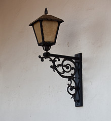 Image showing Ornate glass lantern against wall