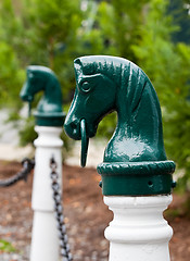 Image showing Green horse head hitch post