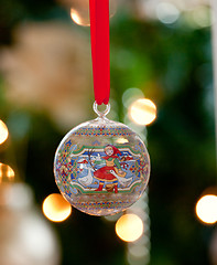 Image showing Glass ornament in front of Christmas tree