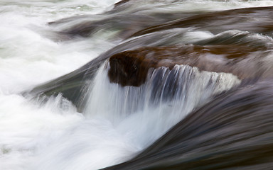 Image showing Rushing river over waterfall