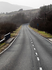 Image showing Single carriageway road into distance