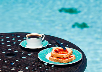 Image showing Breakfast by the pool on sunny day