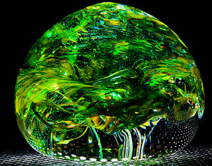 Image showing Green blown glass ball like forest leaves