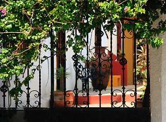 Image showing Ornate iron gates with patio