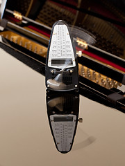 Image showing Metronome ticking and reflected on piano