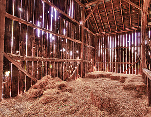 Image showing Interior of old barn with straw bales