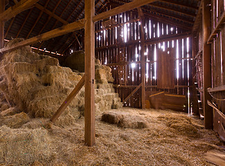 Image showing Interior of old barn with straw bales
