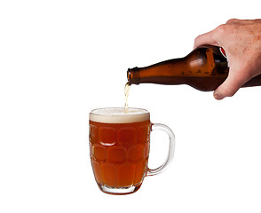 Image showing Beer being poured from bottle into pint