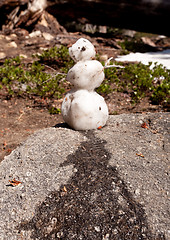 Image showing Melting snowman on granite rock