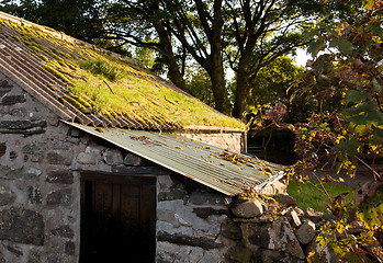 Image showing Old farm building with moss covered roof