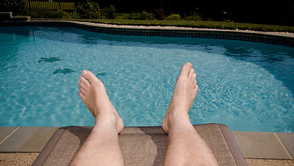 Image showing Old feet overhanging pool