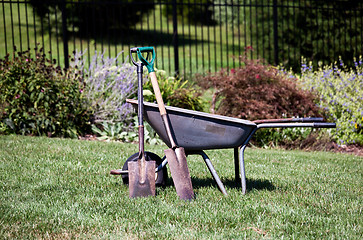 Image showing Wheelbarrow and spades