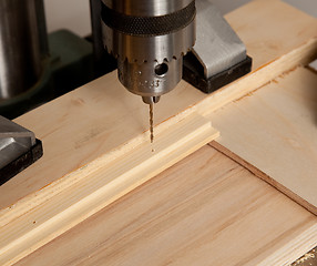 Image showing Drilling small hole in wood