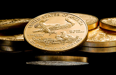 Image showing Macro image of gold eagle coin on stack