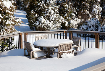 Image showing Snowy modern deck with wooden table