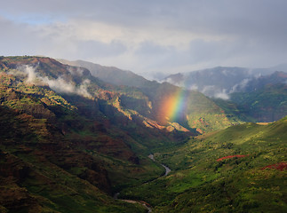 Image showing Rainbow falling on river in Waimea Canyon