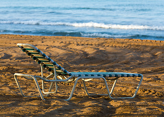 Image showing Olf sun lounger on beach