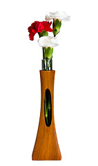 Image showing Red and white spray carnations in teak vase