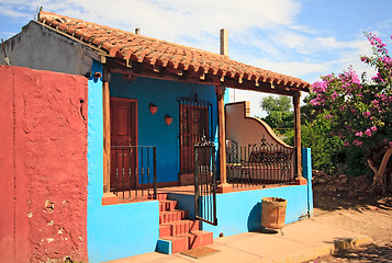 Image showing Blue house with bright red wall