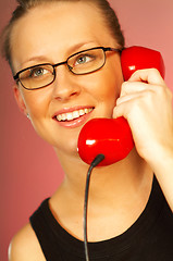 Image showing Women with red phone