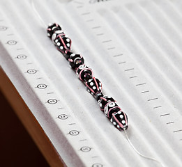 Image showing Line of black and pink beads