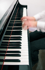 Image showing Pianist hands playing the grand piano