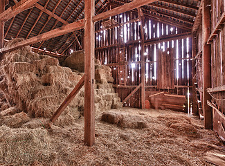 Image showing Interior of old barn with straw bales