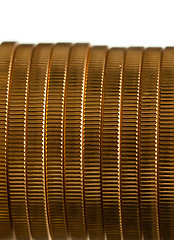 Image showing Edge view of stack of golden coins