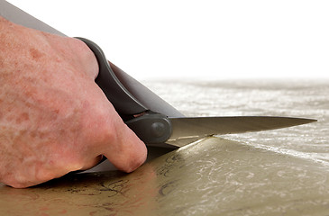 Image showing Scissors cutting decorative wrapping paper